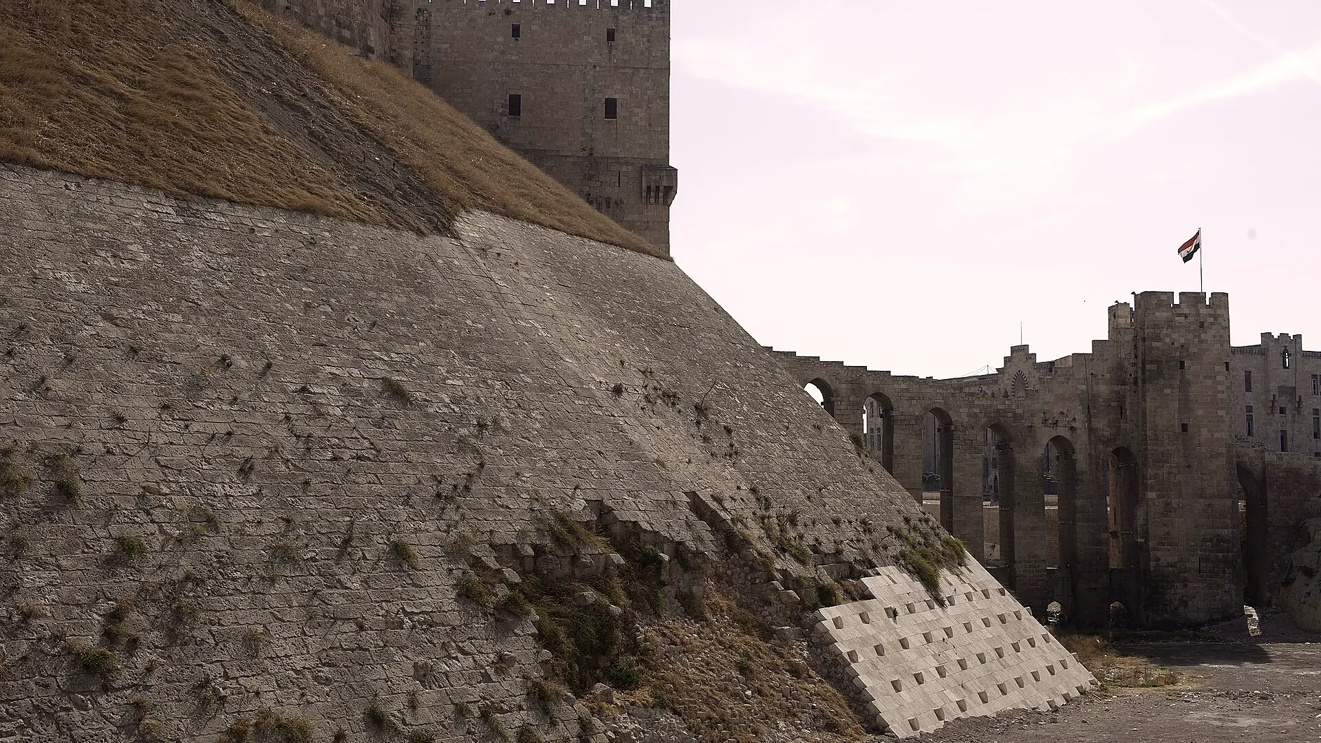 The dressed stone of the glacis running up to the ramparts